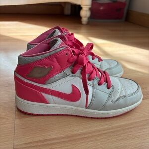 Pink and silver Nike Jordan mids